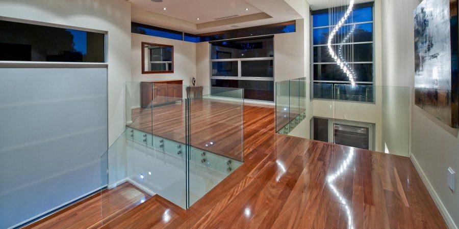 Glossy timber floor and glass balustrade landing, Perth